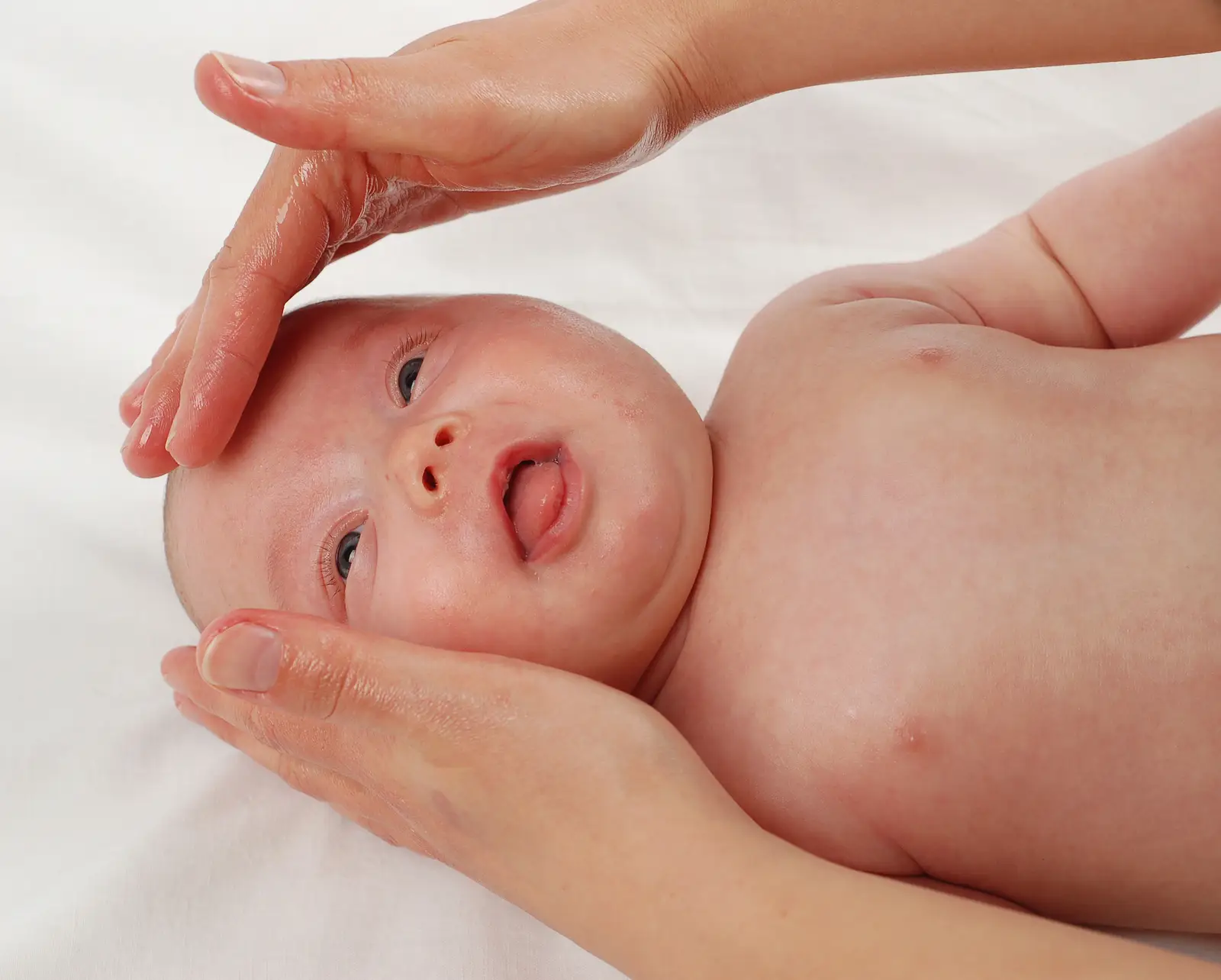 Osteopath providing gentle hands-on treatment to an infant — safe care for babies with colic, reflux and sleep issues