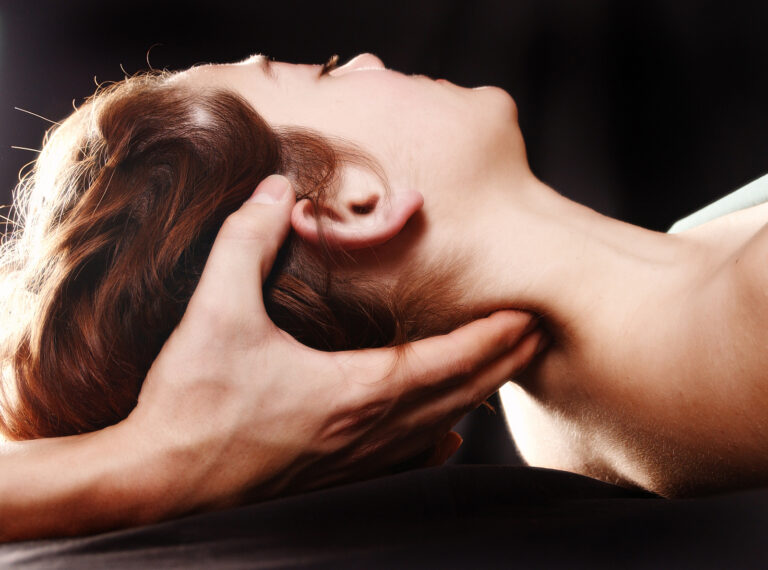 Physiotherapist performing hands-on neck treatment