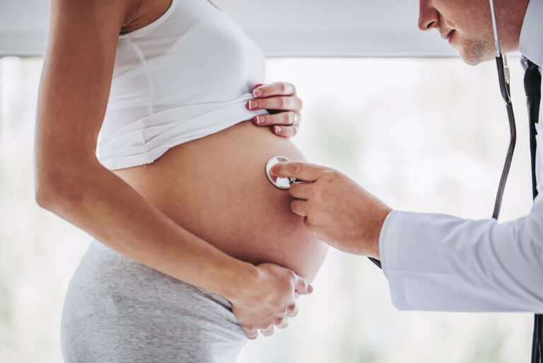 Pregnant woman with doctor