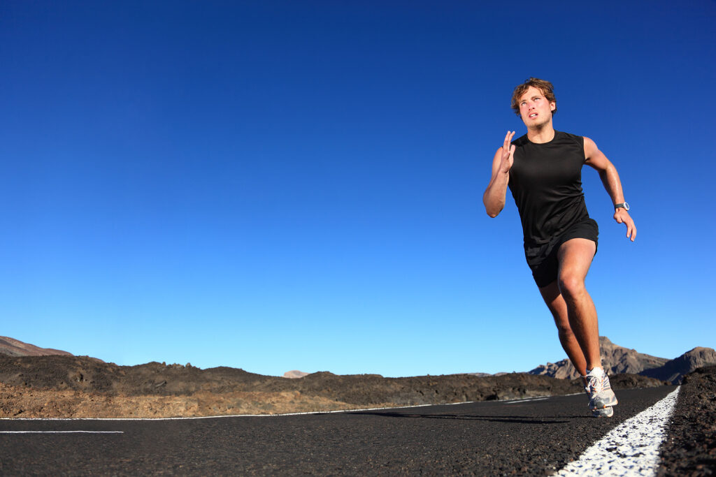 Runner on an open road, where many common running injuries start