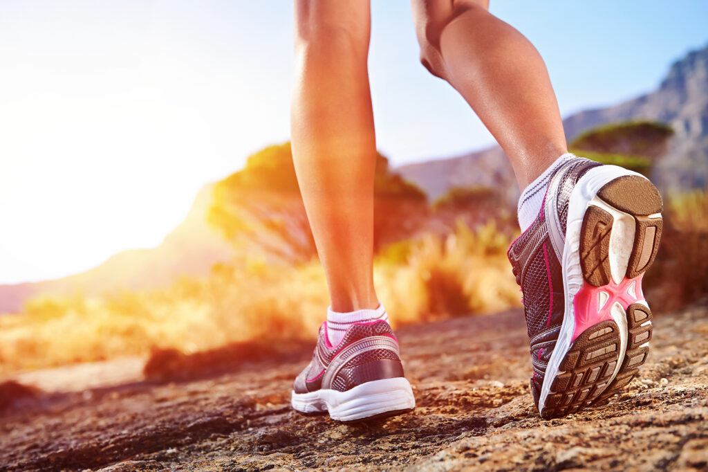 Close-up of running shoes striking the ground during a trail run