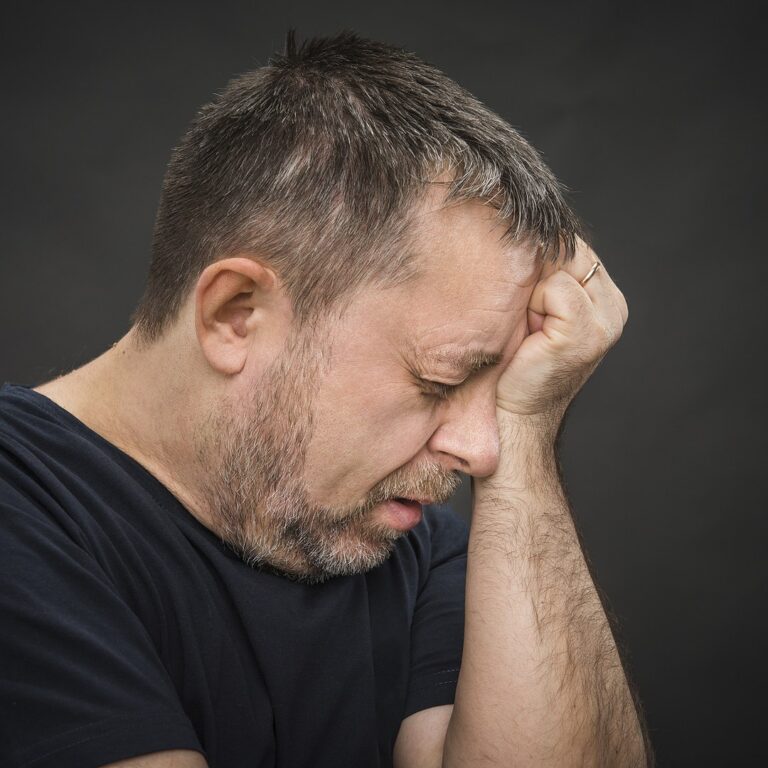 Man holding his head with a migraine headache