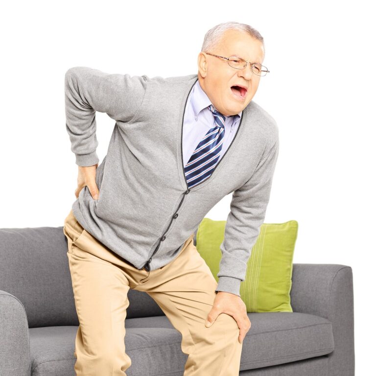 Older man holding his lower back in pain