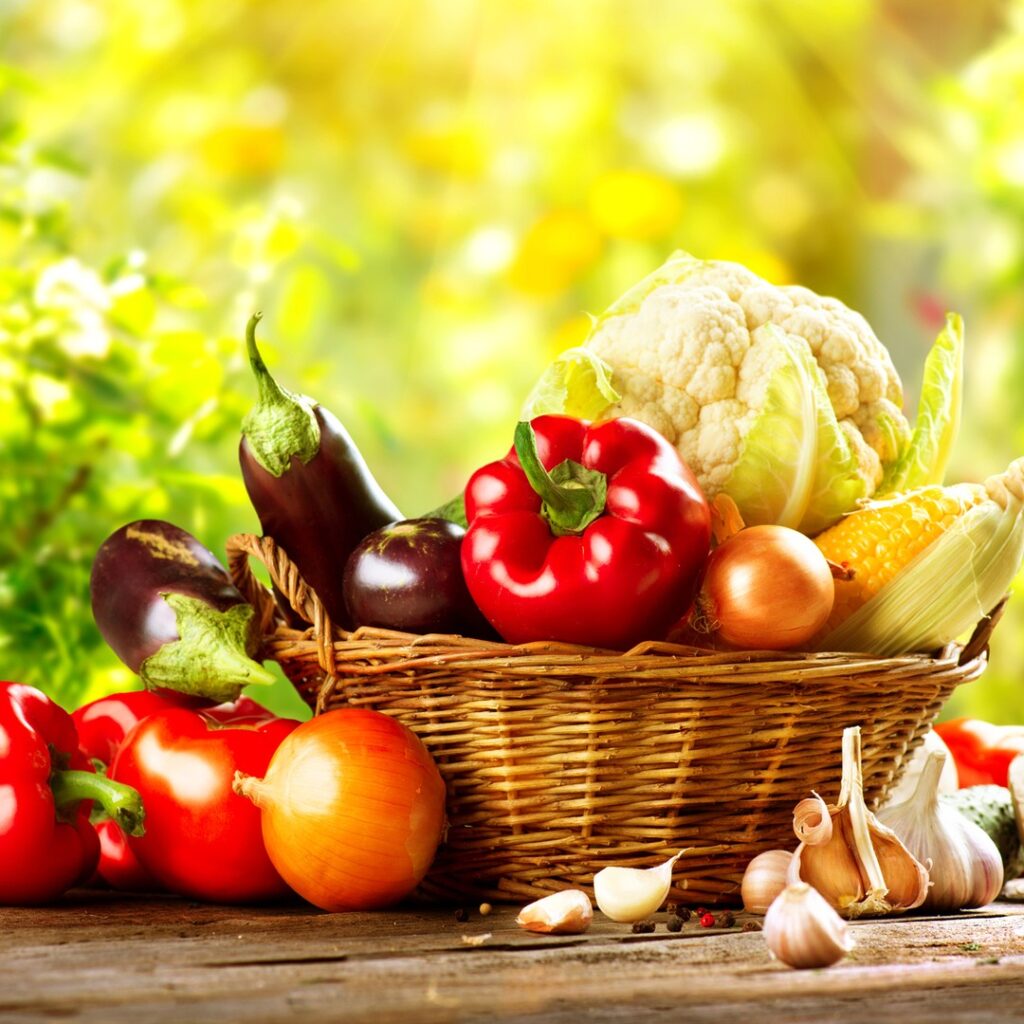Basket of fresh seasonal vegetables and leafy greens for smoothies