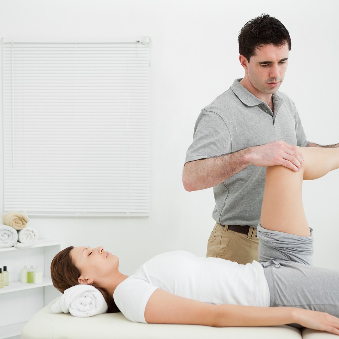 Physiotherapist assessing a patient's leg