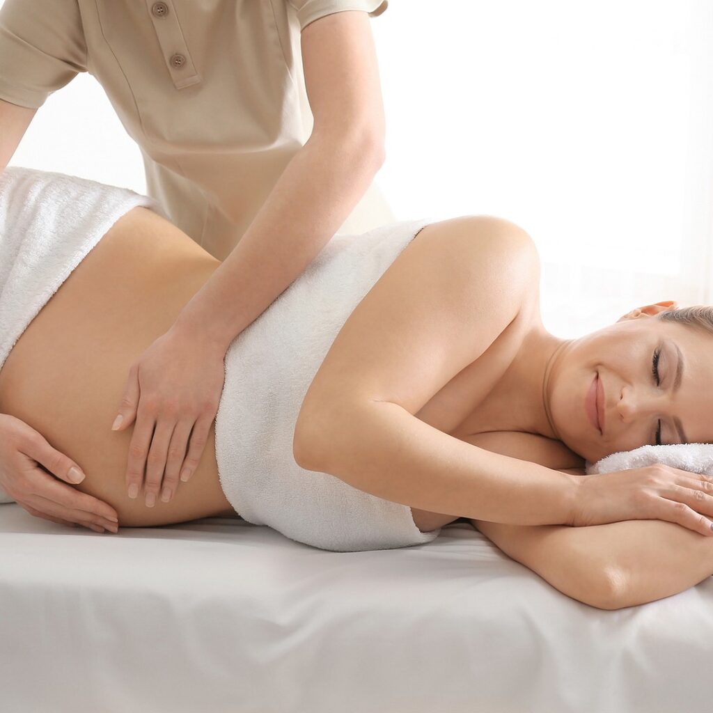 Pregnancy massage Orewa &mdash; a pregnant client lying comfortably on her side during a gentle massage