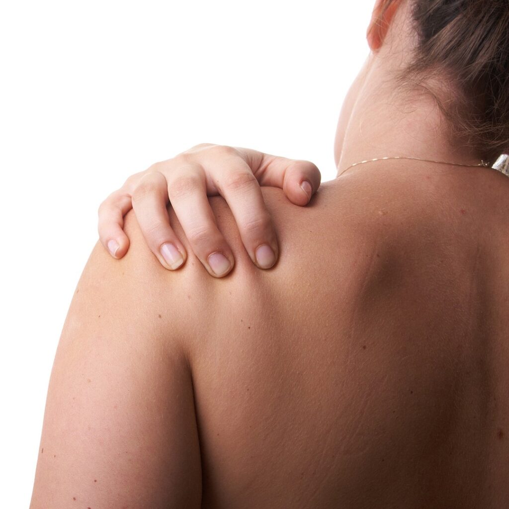 Work Injury Auckland 3 Woman reaching across to hold the top of her shoulder