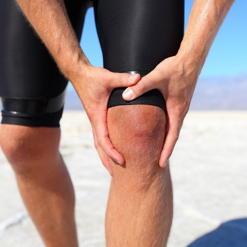 Runner holding a painful knee after exercise on the North Shore